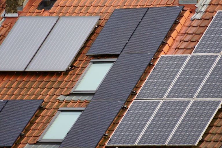 Close-up of solar panels on a tiled roof, showcasing to mount solar panels on a roof rack.